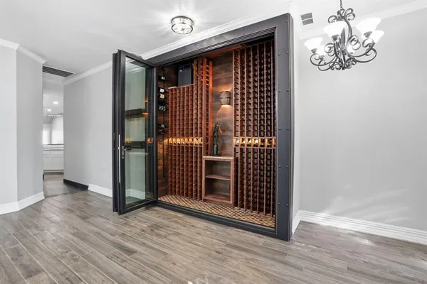a view of a livingroom with wooden floor and chandelier