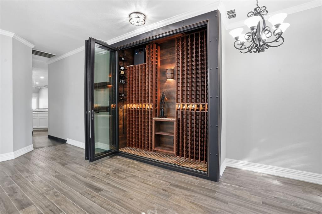 12701 Beech Tree Lane Fort Worth, TX 76040 - Photo 4 of 33 a view of a livingroom with wooden floor and chandelier