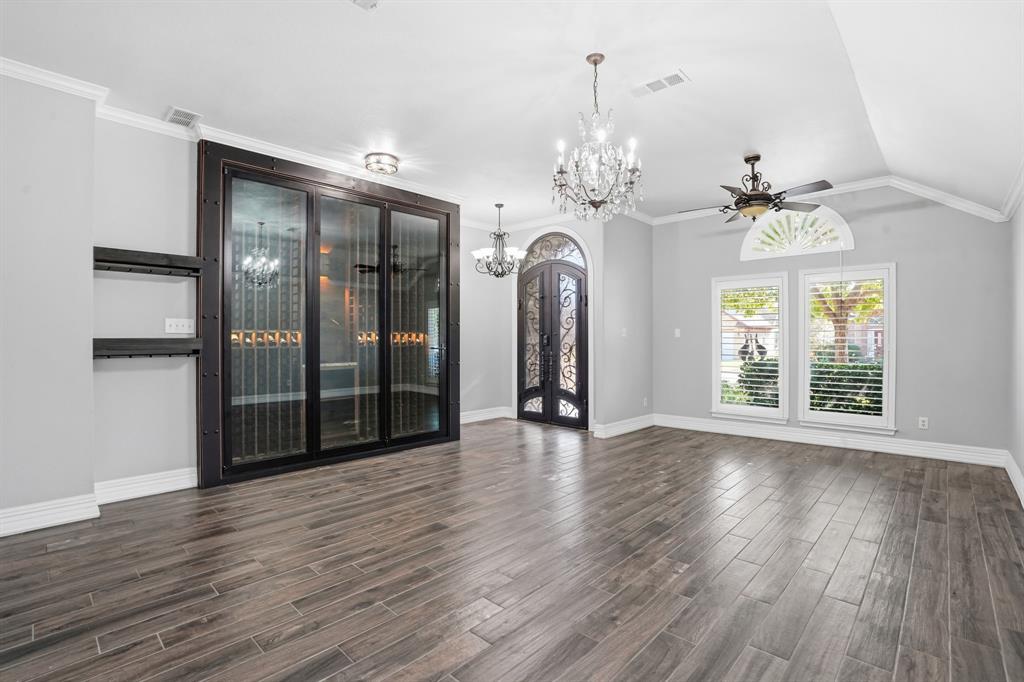 12701 Beech Tree Lane Fort Worth, TX 76040 - Photo 7 of 33 a view of an empty room with wooden floor and a window