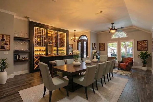 a dining room with furniture window and wooden floor