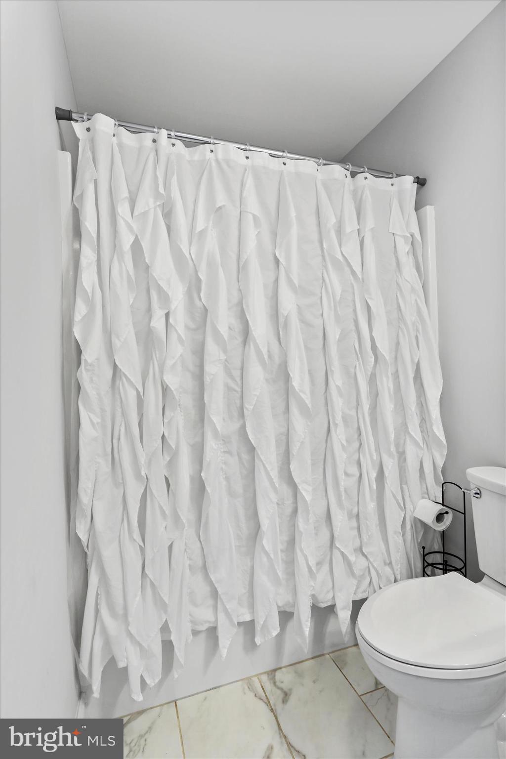 219 Summerfield Way Shenandoah Junction, WV 25442 - Photo 26 of 36 a white toilet sitting next to a shower curtain