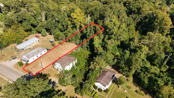 an aerial view of a house with a yard and garden
