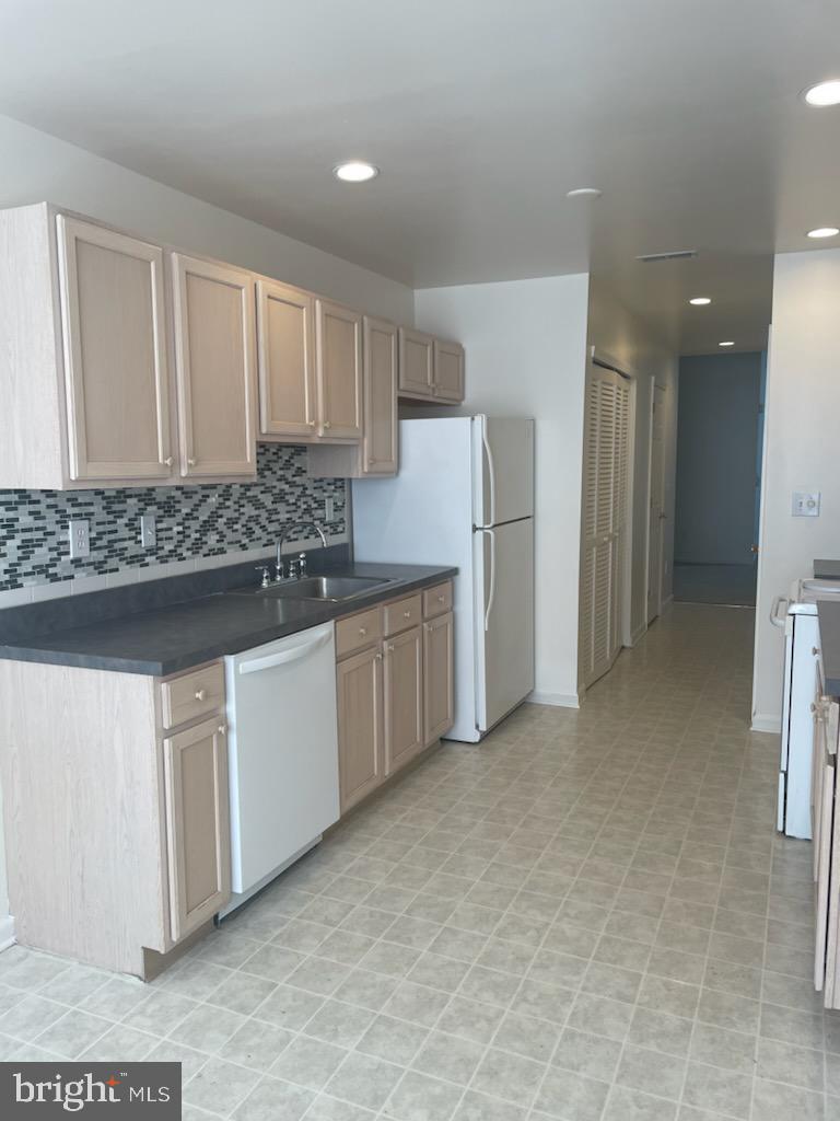 28 Palmer Square Beverly, NJ 08010 - Photo 11 of 12 a kitchen with white cabinets and refrigerator
