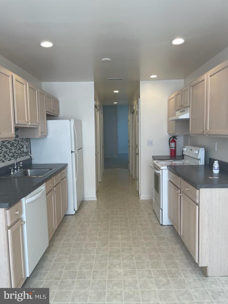 28 Palmer Square Beverly, NJ 08010 - Photo 12 of 12 a kitchen with a sink stove top oven and cabinets