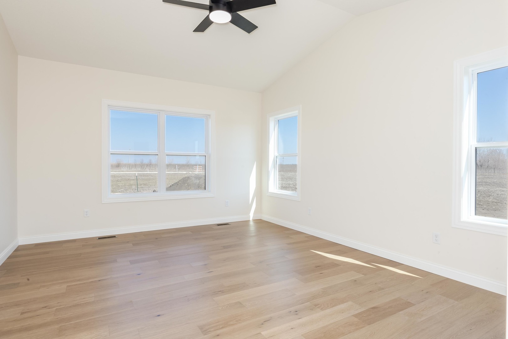 2538 Marble Road Normal, IL 61761 - Photo 15 of 27 an empty room with wooden floor fan and windows