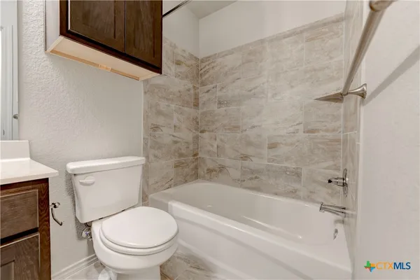 a bathroom with a sink toilet and a mirror