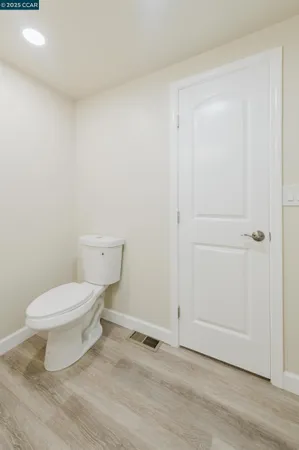 a view of empty room with kitchen and window