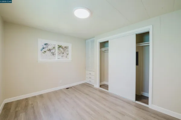 a spacious bathroom with a granite countertop sink and a mirror