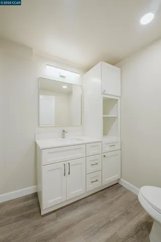 a spacious bathroom with a granite countertop sink and a mirror