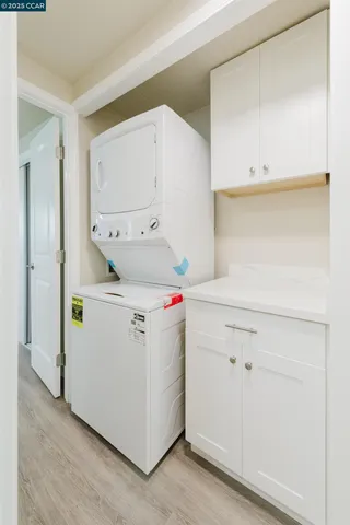a utility room with cabinets washer and dryer
