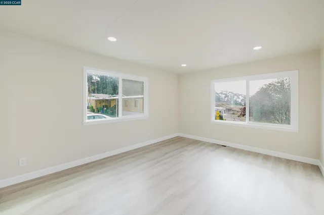 a kitchen with stainless steel appliances kitchen island granite countertop a refrigerator and a stove top oven