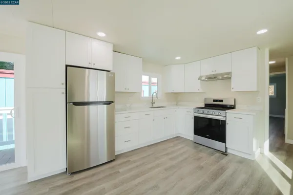 an empty room with a door and wooden floor