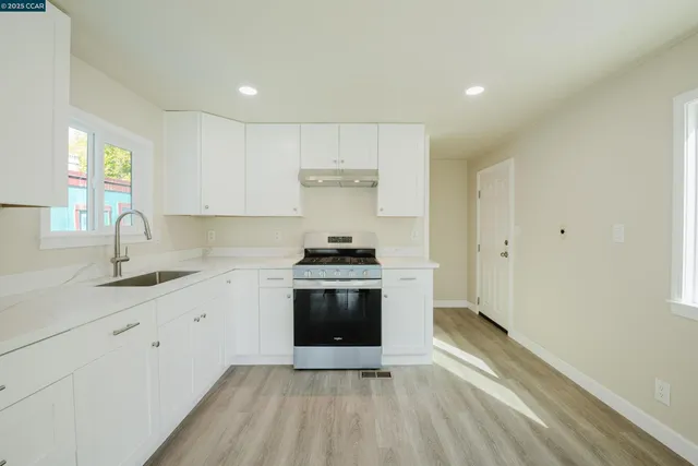 a kitchen with a sink cabinets and stainless steel appliances