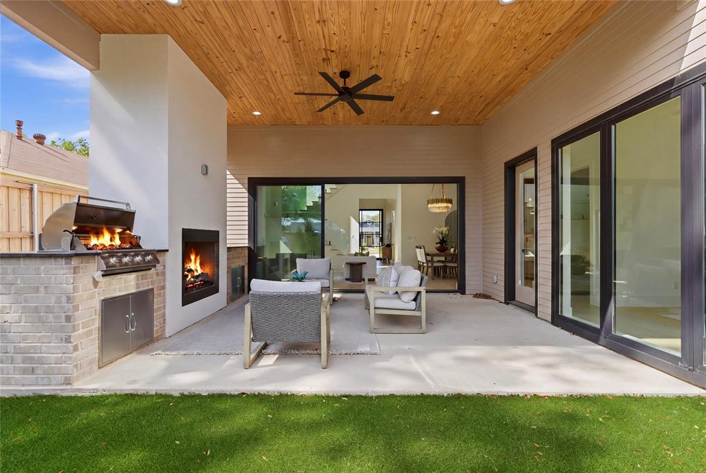 6038 Prospect Avenue Dallas, TX 75206 - Photo 22 of 40 Covered outdoor living space featuring a wood-finish ceiling, built-in fireplace, and an outdoor kitchen with a grill