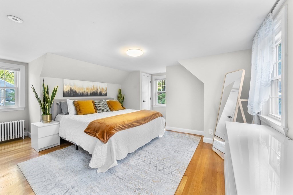 8 Parker Road Needham, MA 02494 - Photo 14 of 28 a spacious bedroom with a bed and a couch