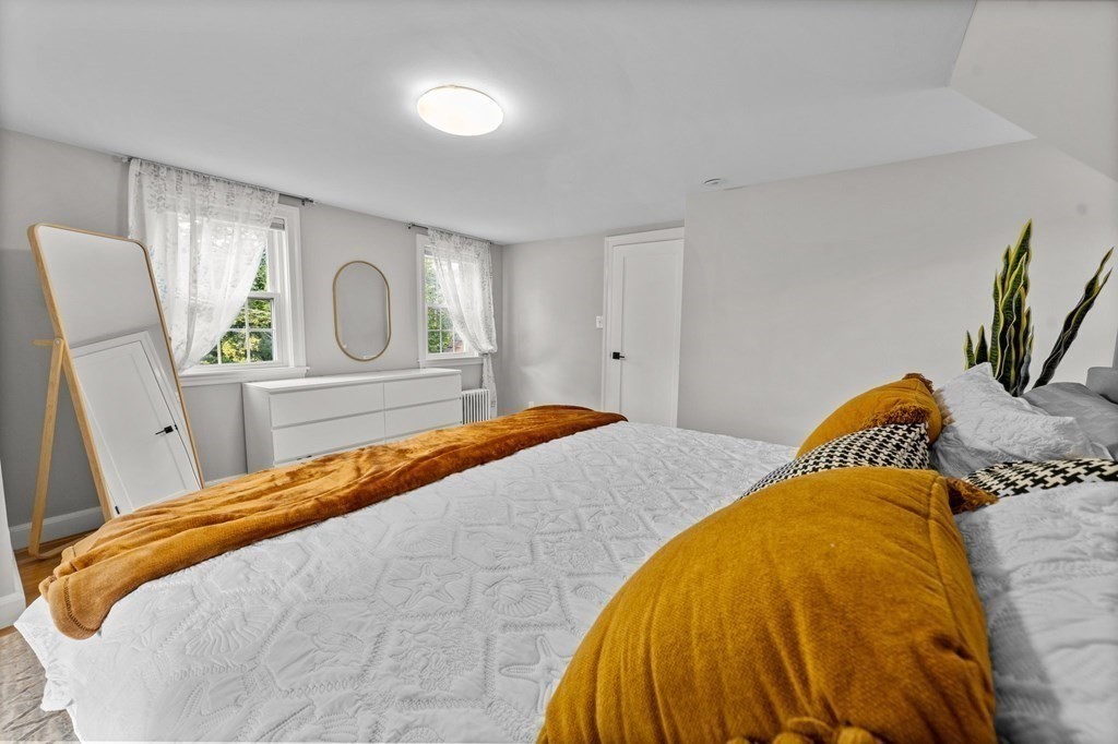 8 Parker Road Needham, MA 02494 - Photo 15 of 28 a bedroom with a bed and painting on the wall