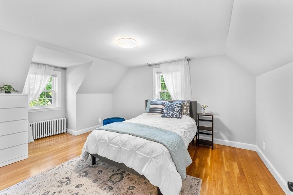 8 Parker Road Needham, MA 02494 - Photo 16 of 28 a bedroom with a bed and wooden floor