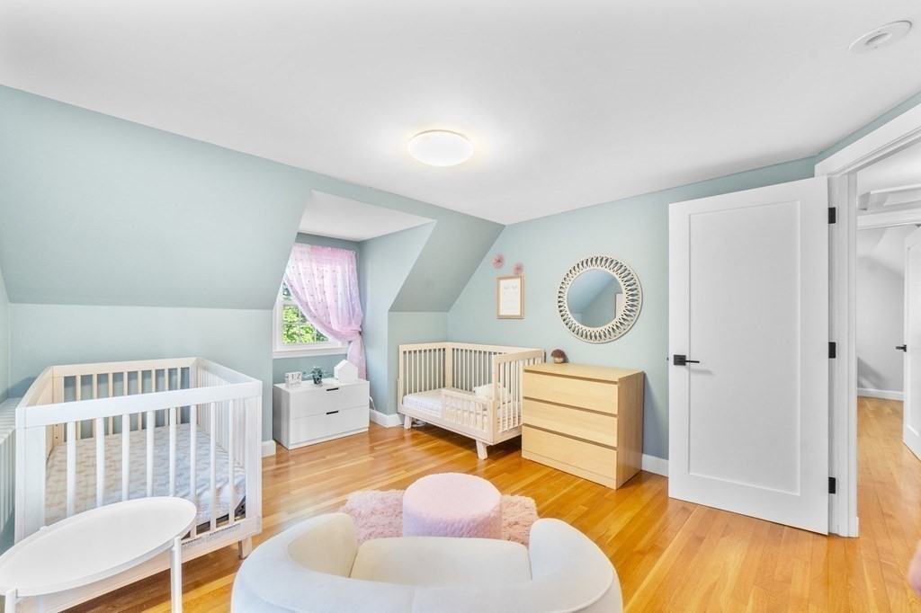 8 Parker Road Needham, MA 02494 - Photo 20 of 28 a bedroom with furniture and a wooden floor