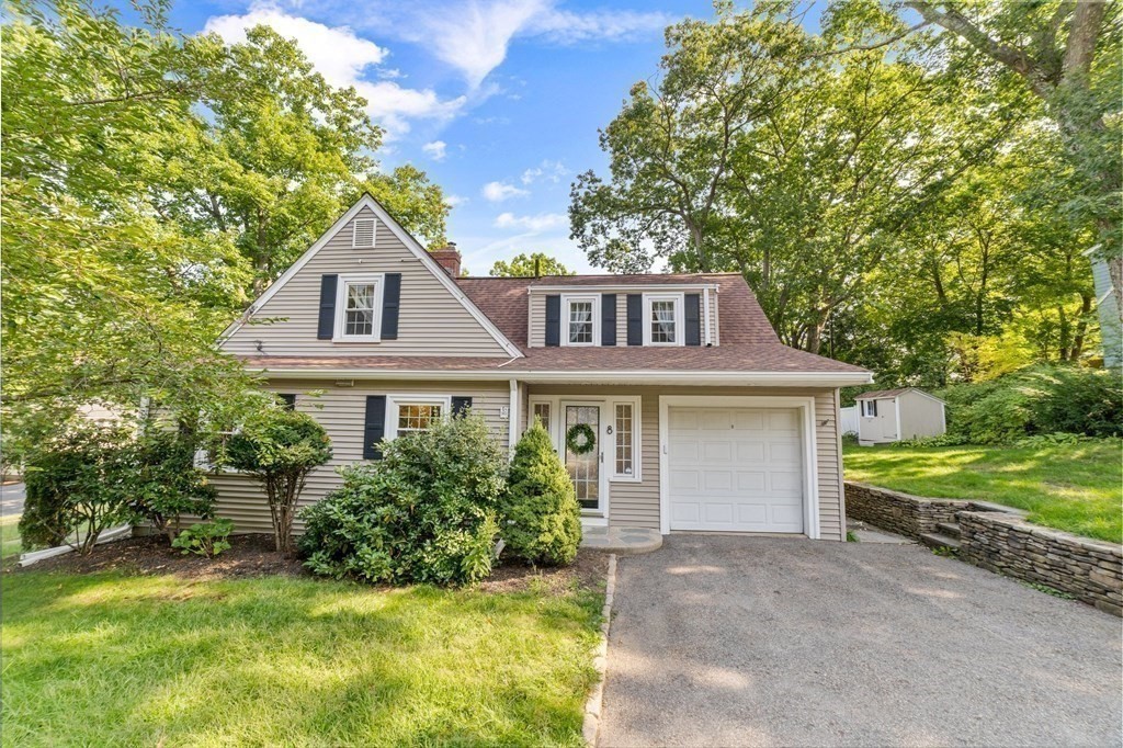 8 Parker Road Needham, MA 02494 - Photo 2 of 28 a front view of a house with a yard and garage