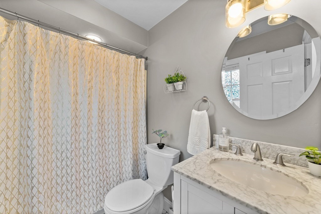 8 Parker Road Needham, MA 02494 - Photo 24 of 28 a bathroom with a granite countertop sink vanity mirror and toilet