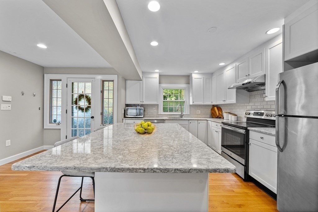 8 Parker Road Needham, MA 02494 - Photo 4 of 28 a kitchen with stainless steel appliances granite countertop a sink a stove and a refrigerator