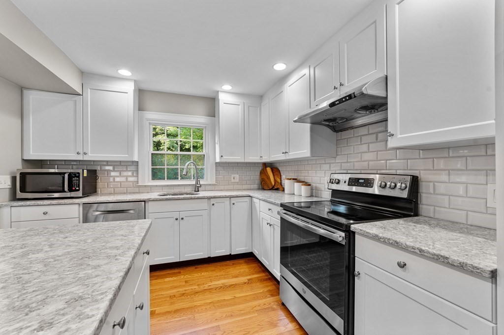 8 Parker Road Needham, MA 02494 - Photo 6 of 28 a kitchen with a sink stove and cabinets