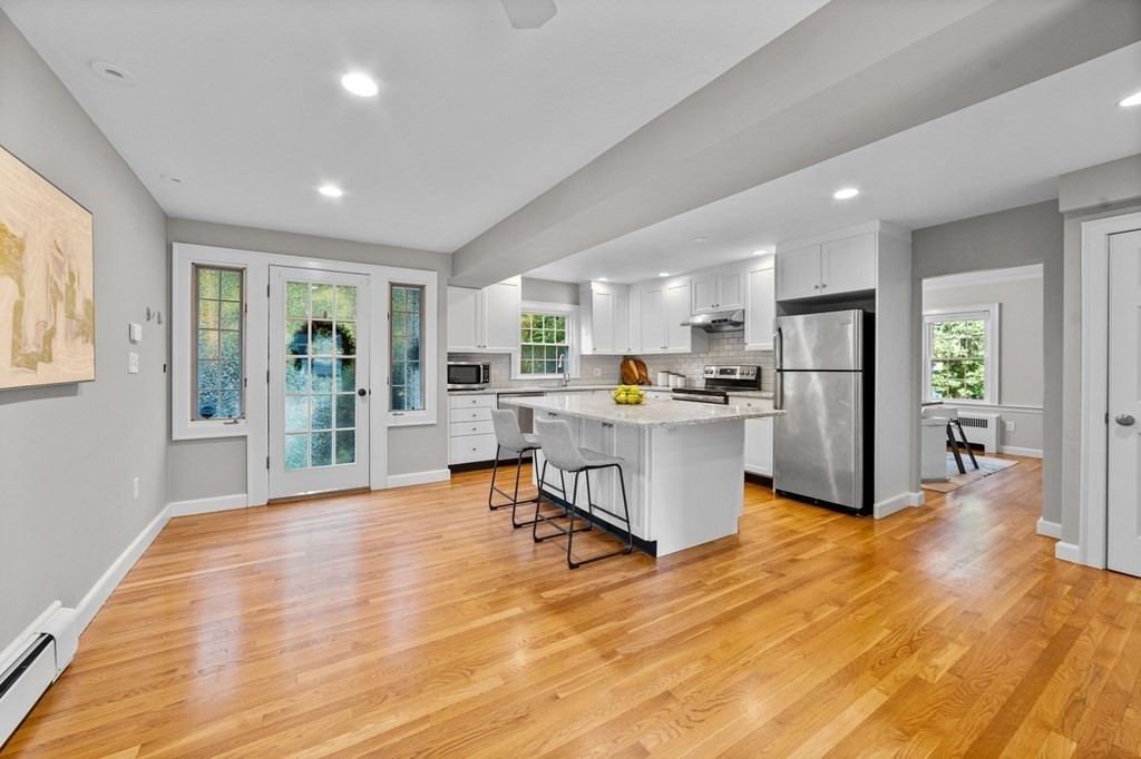 8 Parker Road Needham, MA 02494 - Photo 7 of 28 a living room with stainless steel appliances kitchen island granite countertop furniture and a wooden floor