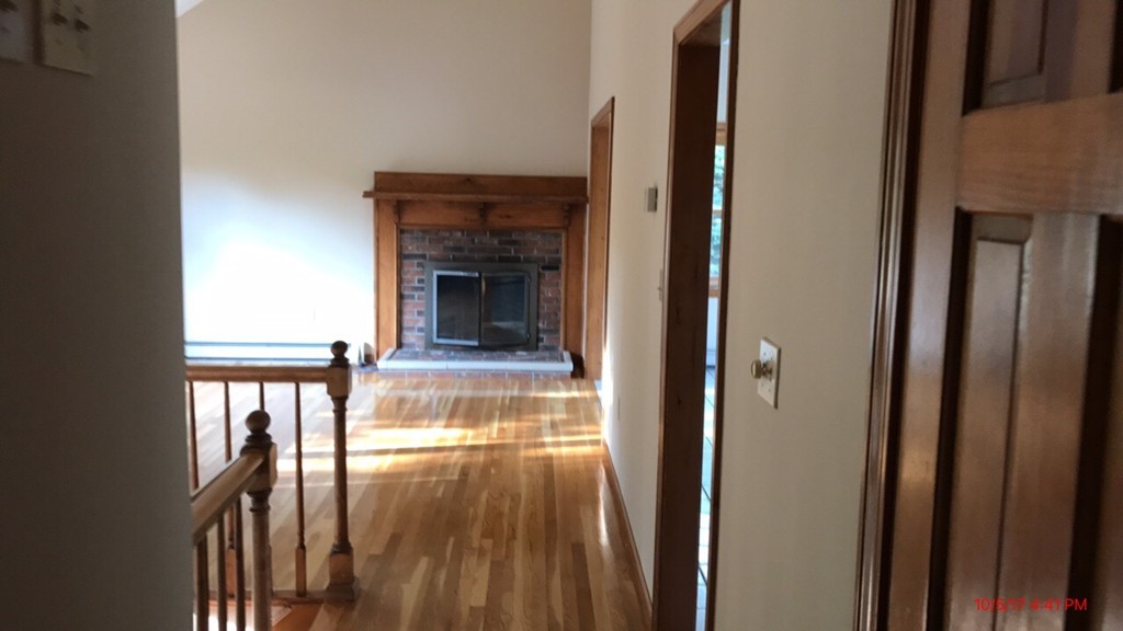 102 Adams Road Grafton, MA 01536 - Photo 20 of 23 a view of a hallway with wooden floor and entryway
