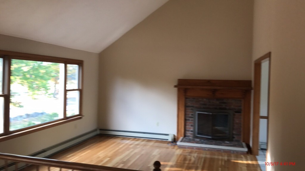 102 Adams Road Grafton, MA 01536 - Photo 21 of 23 a view of an empty room with wooden floor and a window