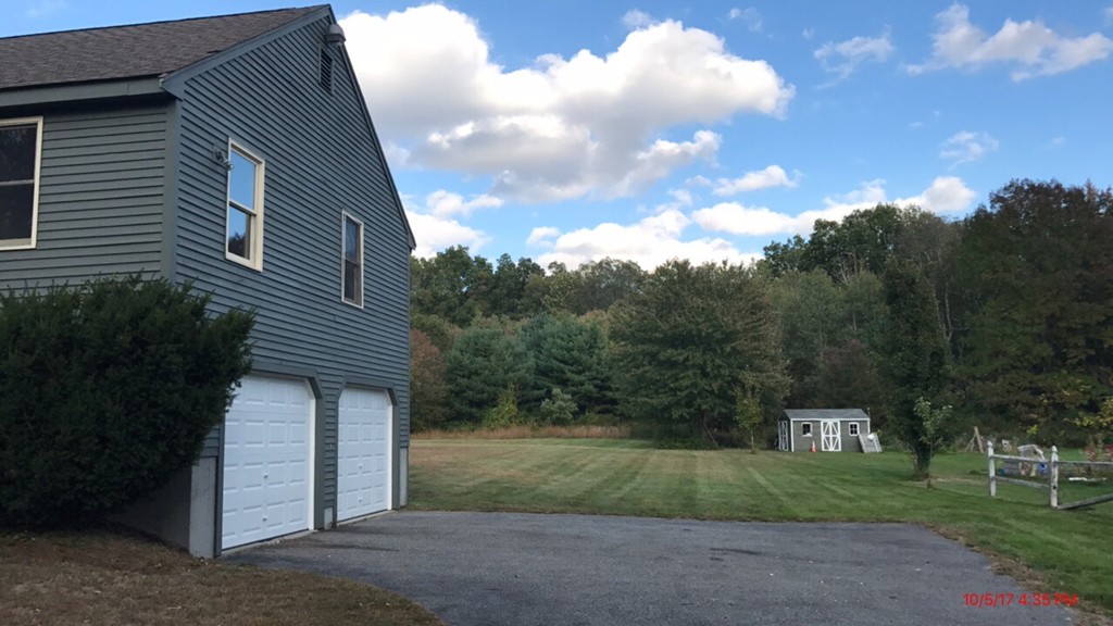 102 Adams Road Grafton, MA 01536 - Photo 3 of 23 a front view of a house with a yard