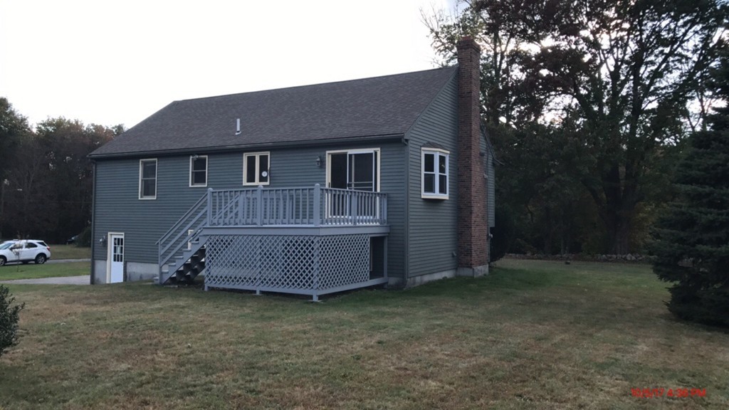 102 Adams Road Grafton, MA 01536 - Photo 6 of 23 a front view of a house with a garden