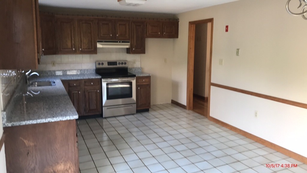 102 Adams Road Grafton, MA 01536 - Photo 9 of 23 a kitchen with a sink cabinets and stainless steel appliances