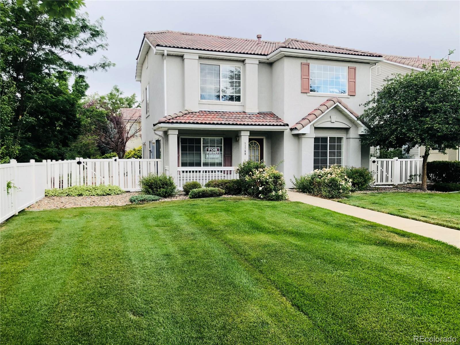 11788 Zenobia Loop Westminster, CO 80031 - Photo 18 of 18 a front view of a house with a yard and porch