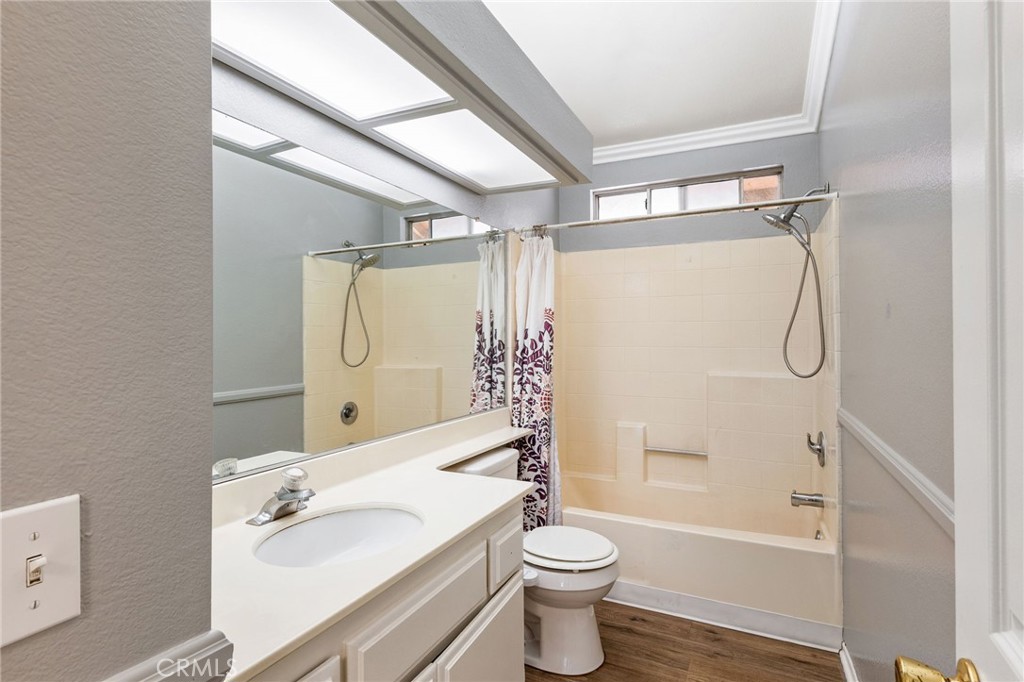 16398 Heather Glen Road Moreno Valley, CA 92551 - Photo 36 of 74 a bathroom with a granite countertop sink toilet and shower