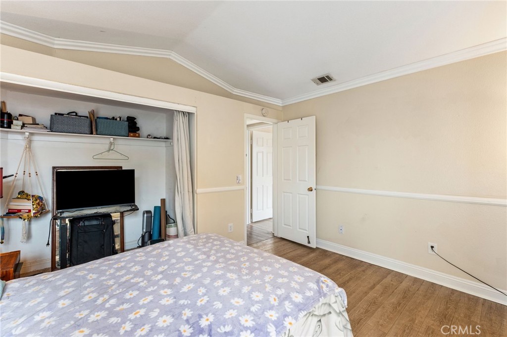 16398 Heather Glen Road Moreno Valley, CA 92551 - Photo 39 of 74 a bedroom with a bed and a flat screen tv