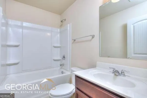 a bathroom with a sink a toilet and a bathtub