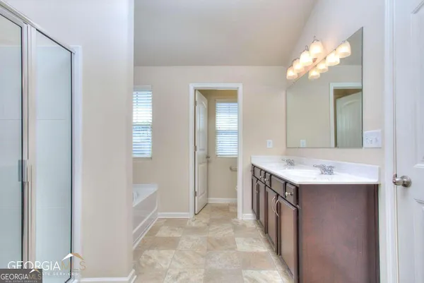 a bathroom with a sink a mirror and a bathtub
