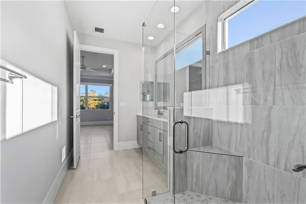 a bathroom with a shower and a sink