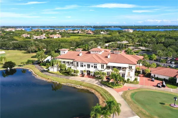 an aerial view of residential houses with outdoor space and river