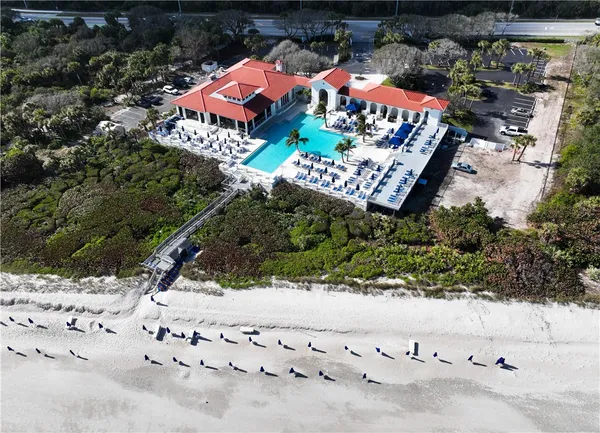 a view of swimming pool with outdoor seating and lake view