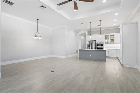 a view of kitchen with refrigerator and microwave