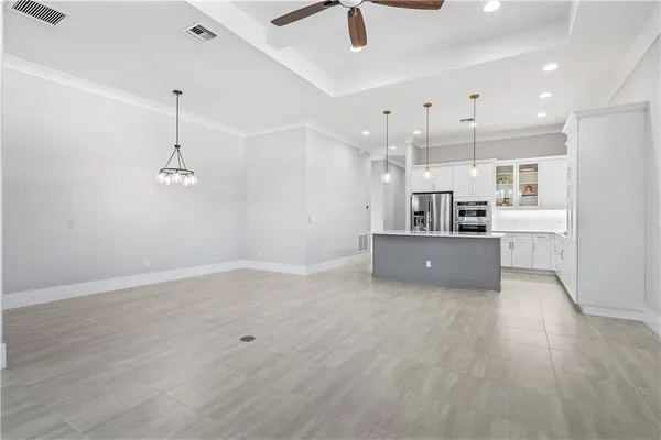 a view of kitchen with refrigerator and microwave
