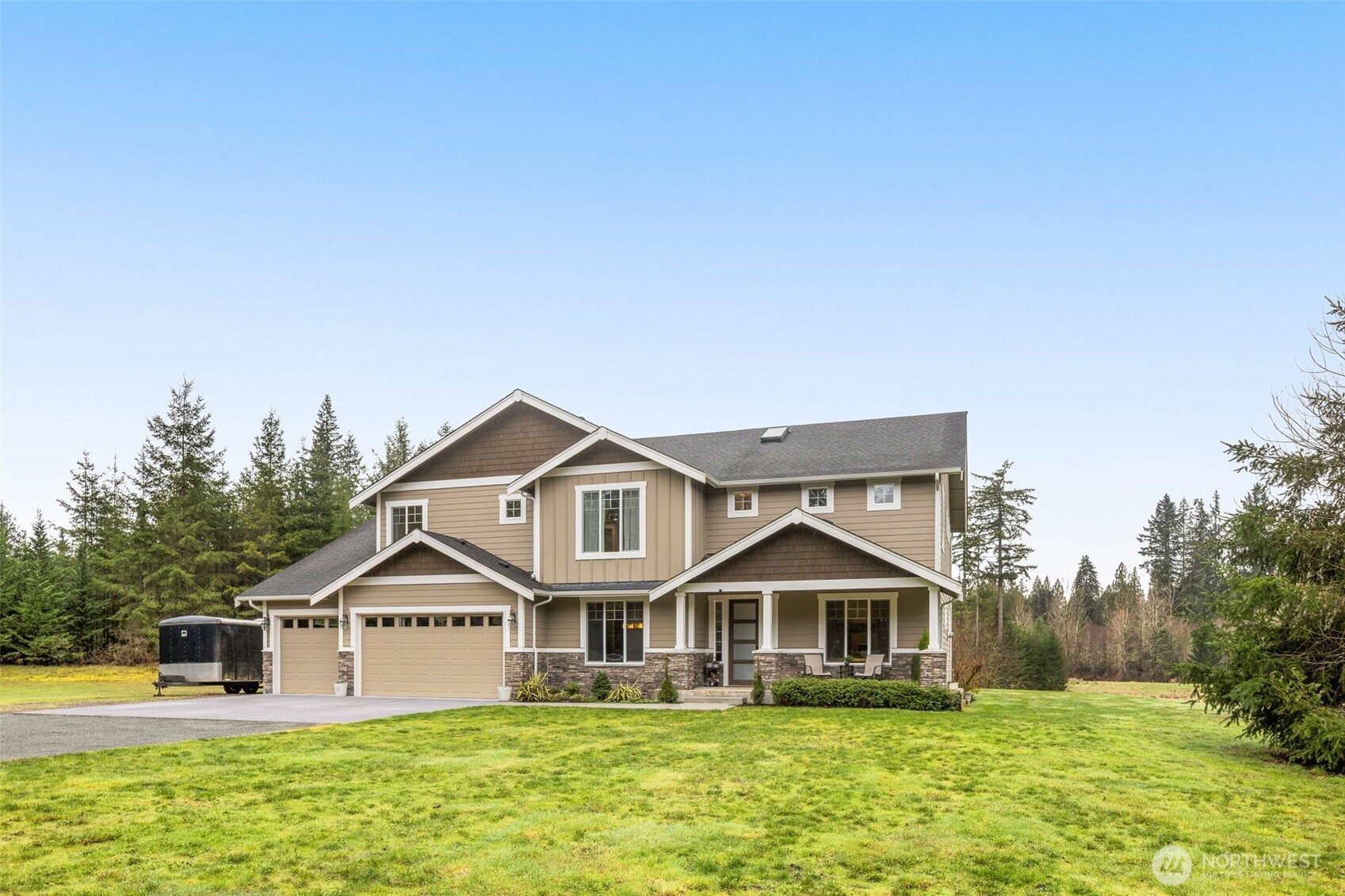 10219 Kelly Road Northeast Carnation, WA 98014 - Photo 1 of 38 a front view of a house with a yard table and chairs