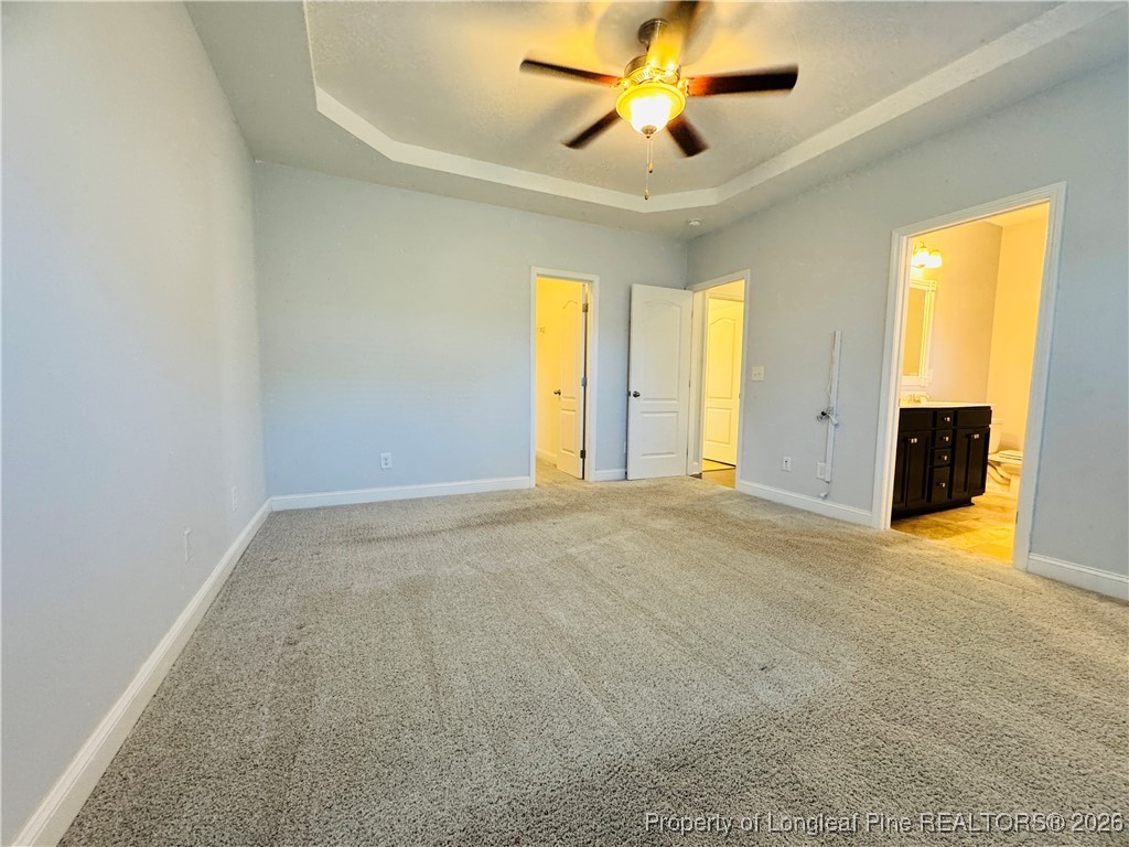 66 Timber Skip Drive Spring Lake, NC 28390 - Photo 13 of 26 an empty room with windows and a ceiling fan