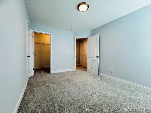 an empty room with closet and a window