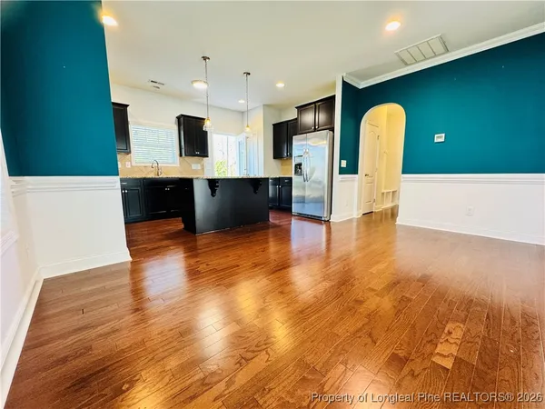 a view of kitchen with cabinets and wooden floor