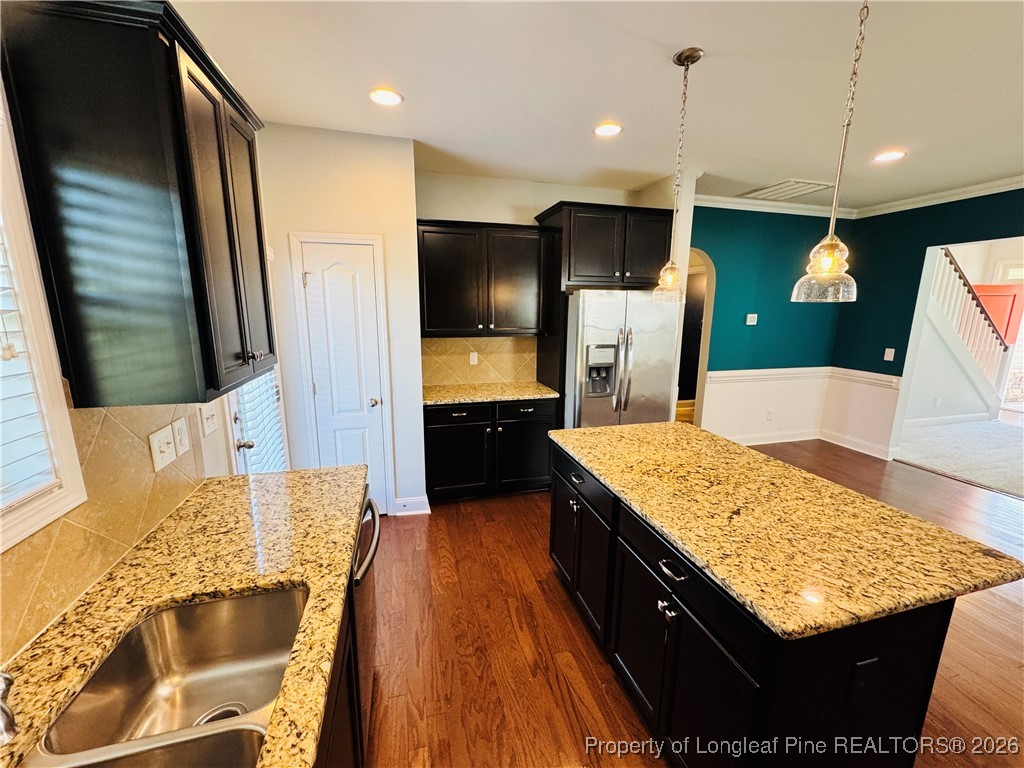 66 Timber Skip Drive Spring Lake, NC 28390 - Photo 8 of 26 a kitchen with stainless steel appliances kitchen island granite countertop wooden cabinets and granite counter tops