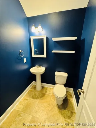 a bathroom with a toilet and a sink