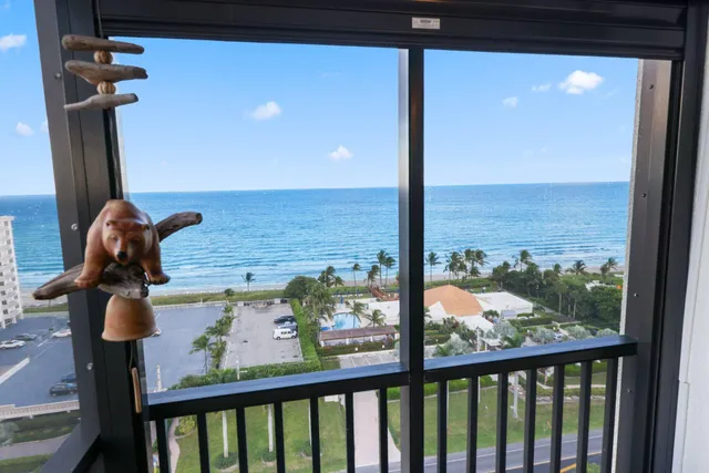 a living room with furniture a flat screen tv and a large window