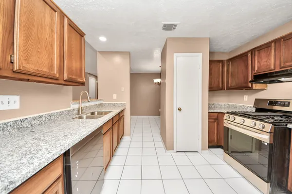 a kitchen with a sink stove and cabinets
